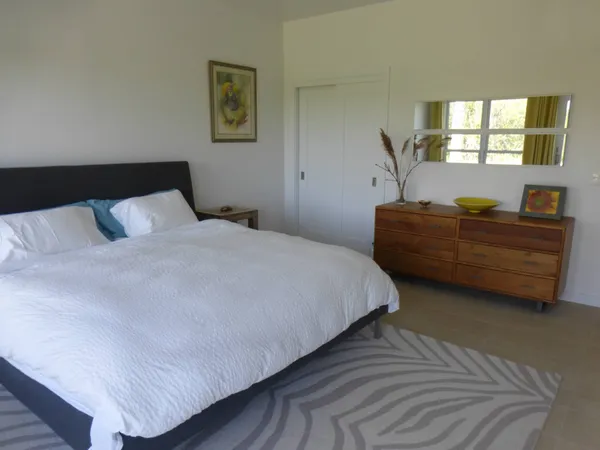 a bedroom with a bed and window