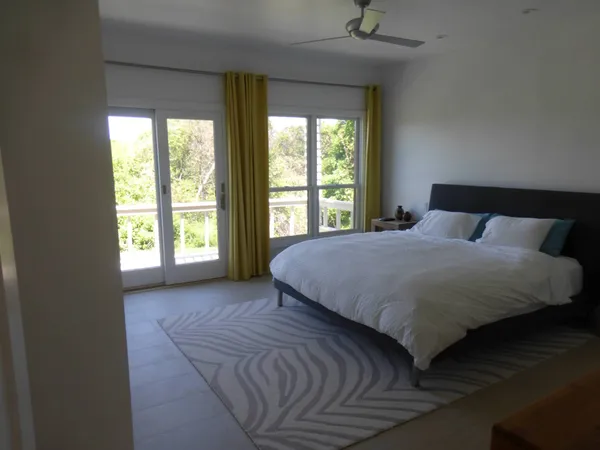 a bedroom with a large bed and a large window