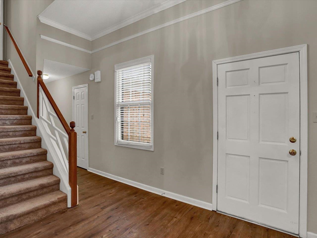 560 Fletcher Road Collierville, TN 38017 - Photo 4 of 25 wooden floor in an empty room with a window