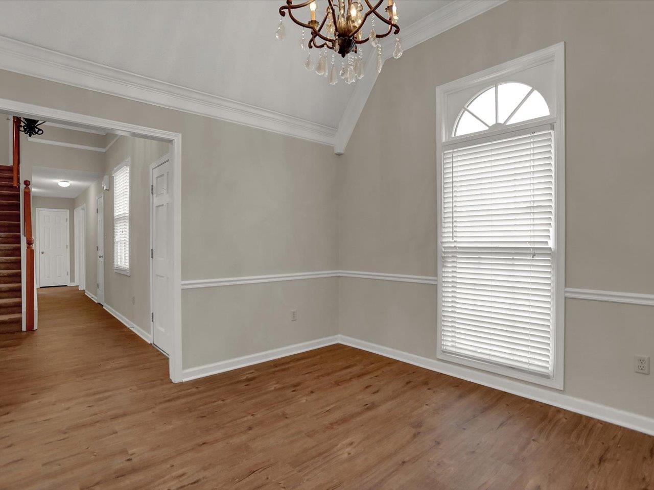 560 Fletcher Road Collierville, TN 38017 - Photo 5 of 25 an empty room with wooden floor and windows