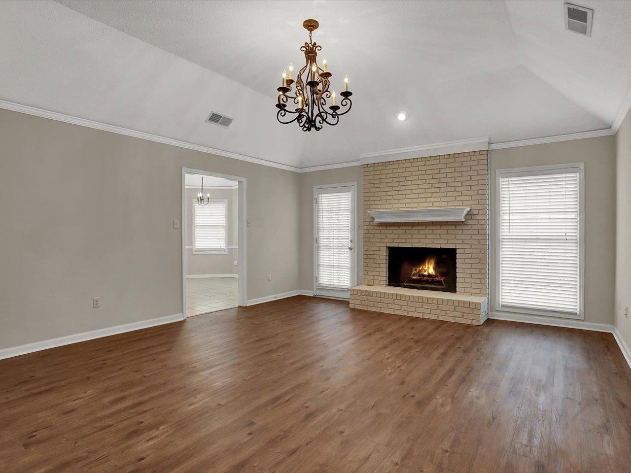 560 Fletcher Road Collierville, TN 38017 - Photo 7 of 25 a view of an empty room with wooden floor fireplace and a window
