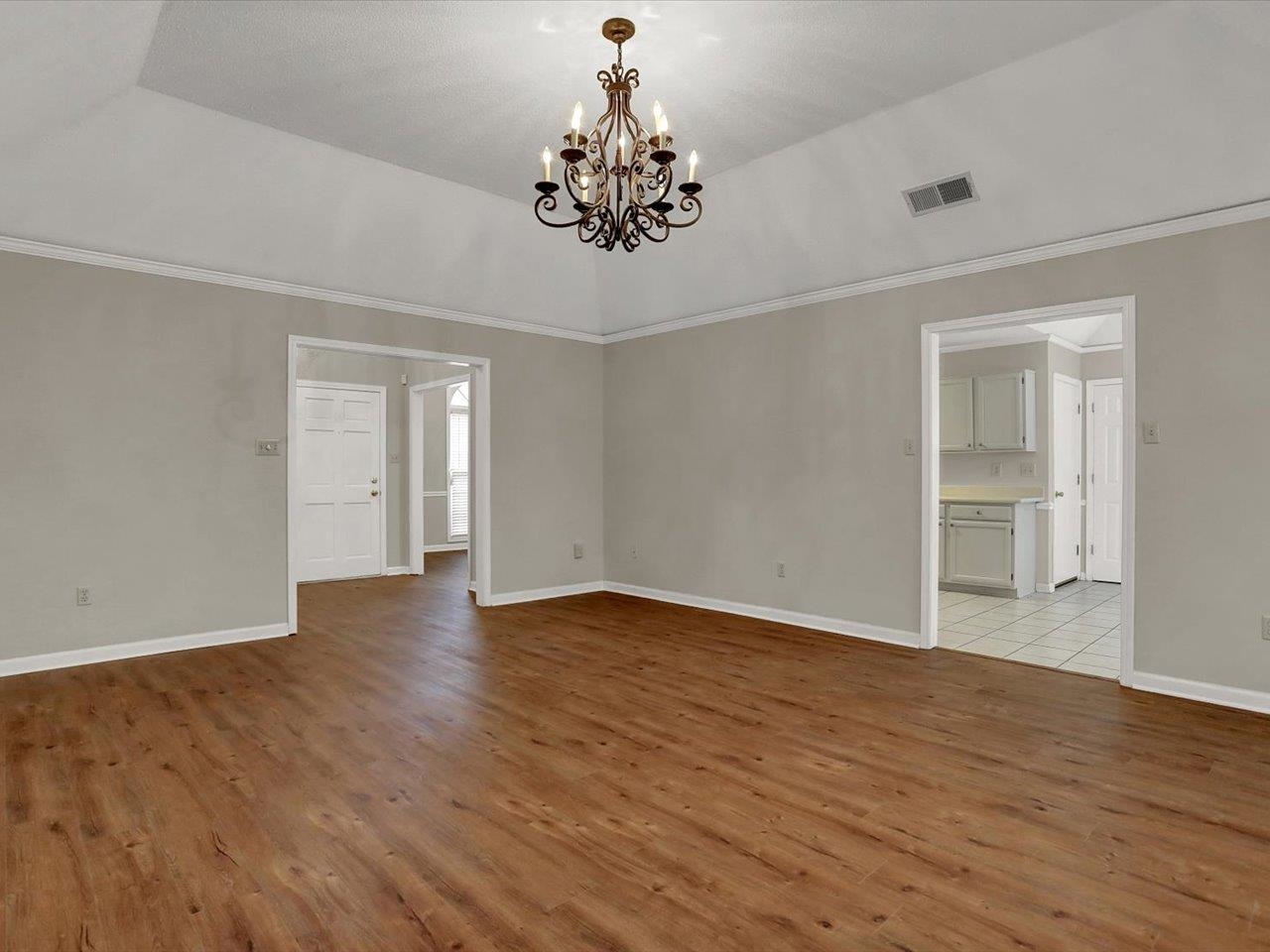 560 Fletcher Road Collierville, TN 38017 - Photo 8 of 25 a view of an empty room with wooden floor and a window