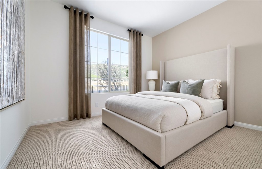 8141 Tristan Lane Riverside, CA 92507 - Photo 13 of 15 a large bed sitting in a bedroom next to a window