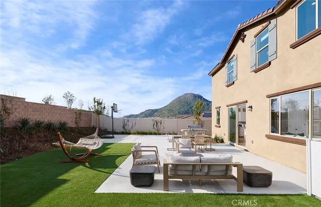 a kitchen with stainless steel appliances kitchen island granite countertop a table chairs and a refrigerator