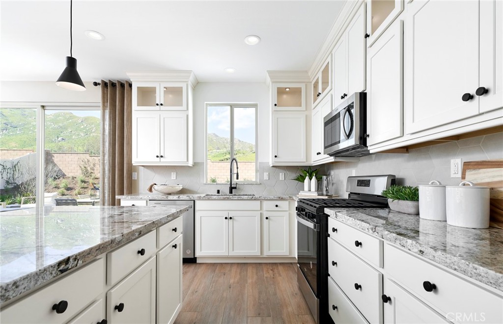 8141 Tristan Lane Riverside, CA 92507 - Photo 2 of 15 a kitchen with cabinets appliances a sink and a window