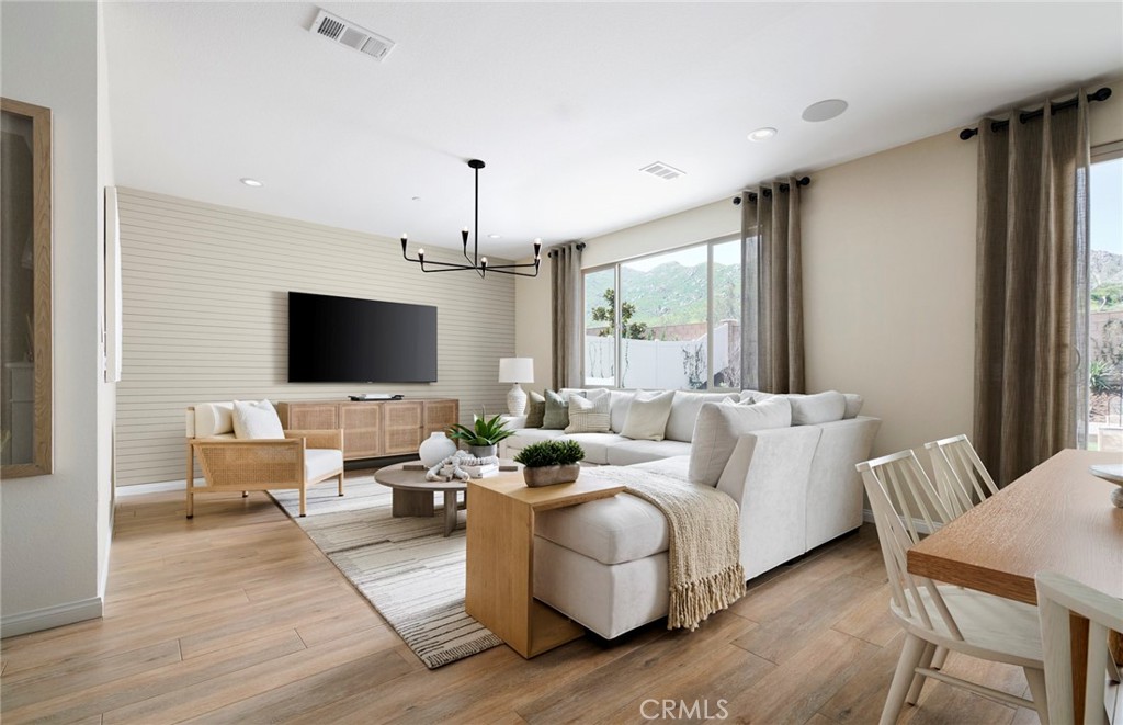 8141 Tristan Lane Riverside, CA 92507 - Photo 3 of 15 a living room with furniture flat screen tv and a large window