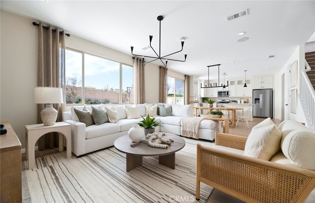 8141 Tristan Lane Riverside, CA 92507 - Photo 5 of 15 a living room with furniture a large window and a chandelier