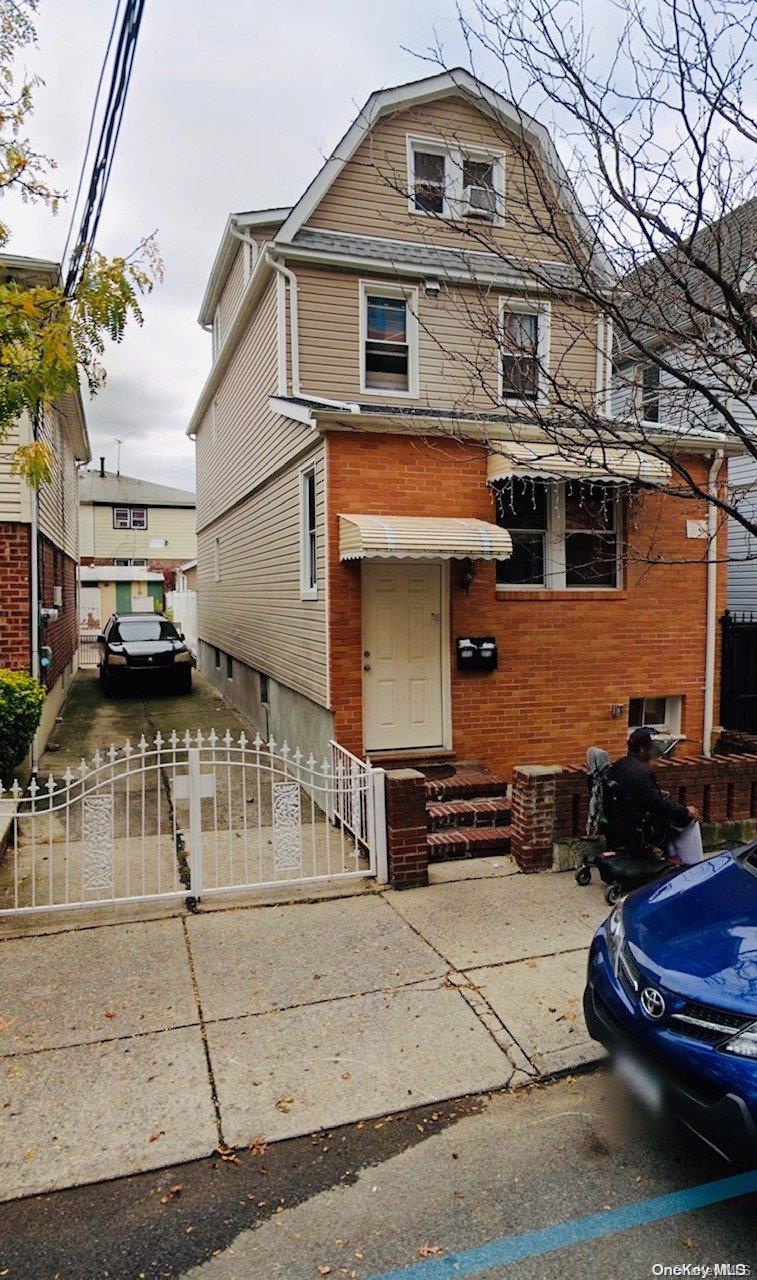 34-70 112th Street Queens, NY 11368 - Photo 1 of 1 a front view of a house with a garage