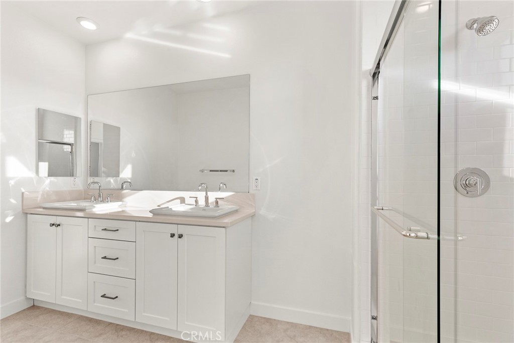 234 Siena Lake Forest, CA 92630 - Photo 17 of 22 a bathroom with a granite countertop sink two mirror and a