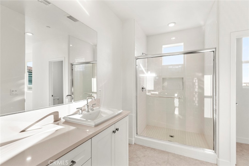 234 Siena Lake Forest, CA 92630 - Photo 18 of 22 a bathroom with a shower sink and mirror