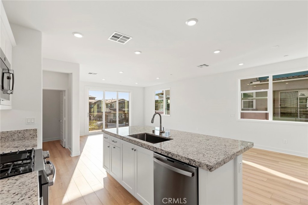 234 Siena Lake Forest, CA 92630 - Photo 7 of 22 a kitchen with granite countertop a stove and a sink