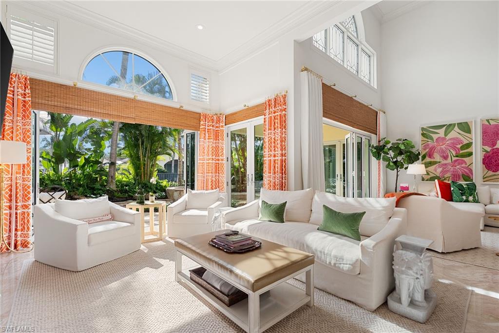 248 Point Salerno Naples, FL 34108 - Photo 1 of 42 a living room with furniture and a large window