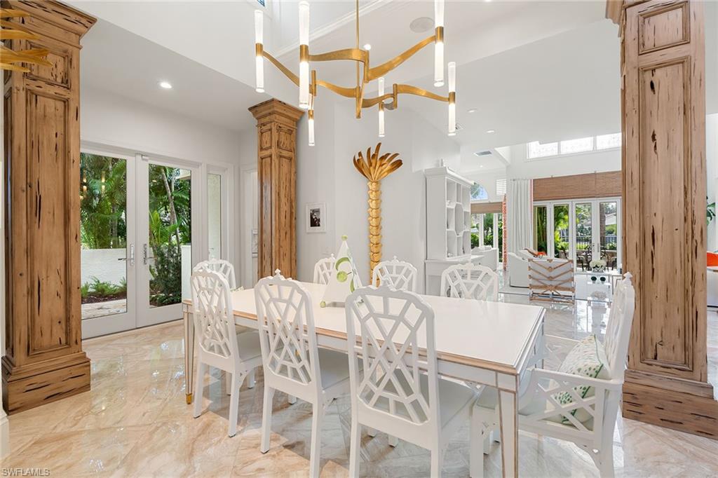 248 Point Salerno Naples, FL 34108 - Photo 17 of 42 a view of a dining room with furniture large windows and wooden floor