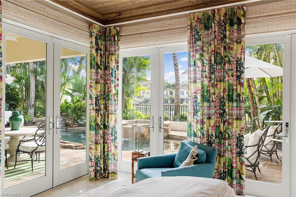 248 Point Salerno Naples, FL 34108 - Photo 18 of 42 a living room with furniture and a floor to ceiling window