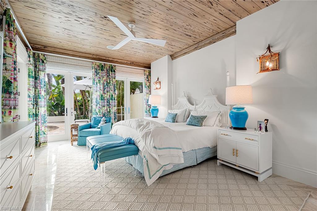 248 Point Salerno Naples, FL 34108 - Photo 19 of 42 a bedroom with a bed and a large window