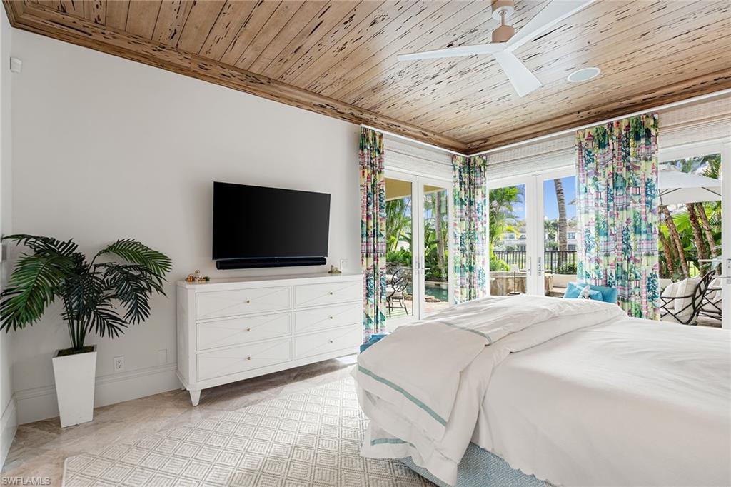 248 Point Salerno Naples, FL 34108 - Photo 20 of 42 a bedroom with furniture and a flat screen tv