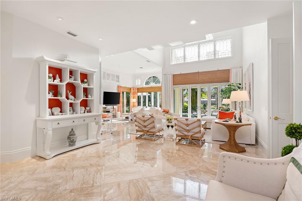 248 Point Salerno Naples, FL 34108 - Photo 10 of 42 a living room with fireplace furniture and a flat screen tv