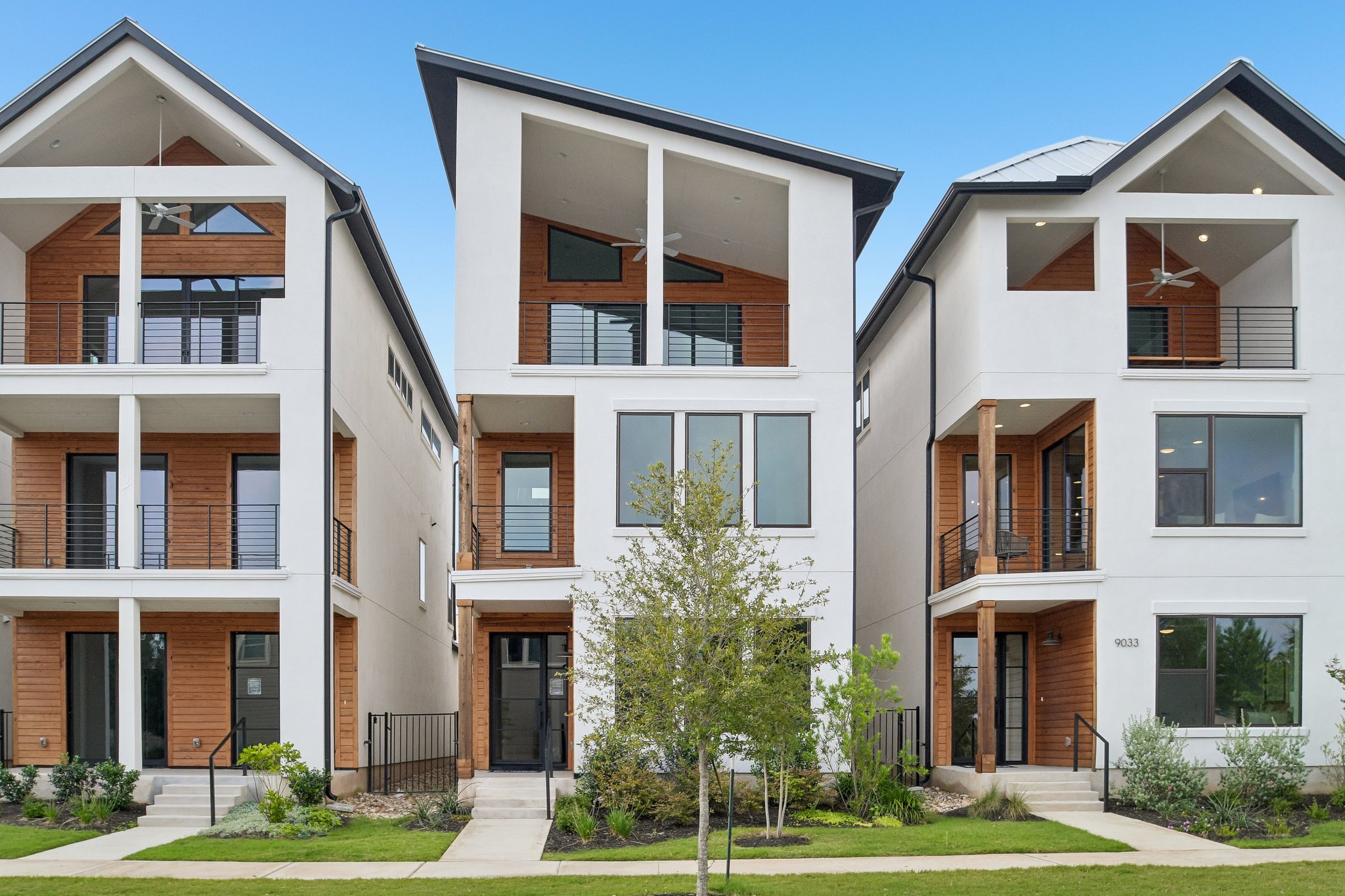Clean lines and wood accents define these modern townhomes with private balconies.
