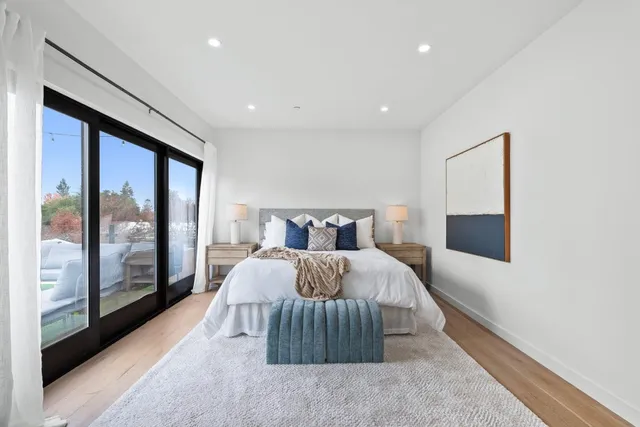 a bedroom with a large bed and a large window