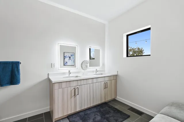 a bathroom with a sink a toilet and mirror