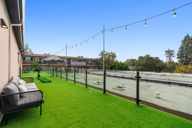 a view of a chair and table in the garden