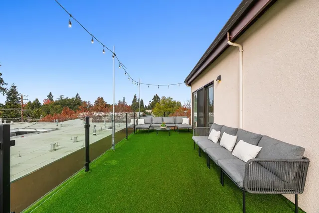 a view of a backyard with sitting area