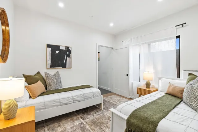 a bedroom with a bed and a couch