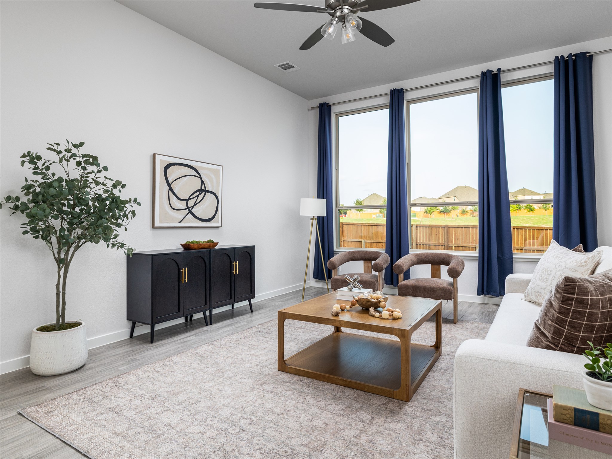 606 Spinnaker Loop Kyle, TX 78640 - Photo 6 of 37 Bright windows and a vaulted ceiling create an airy, welcoming atmosphere in this spacious living room.