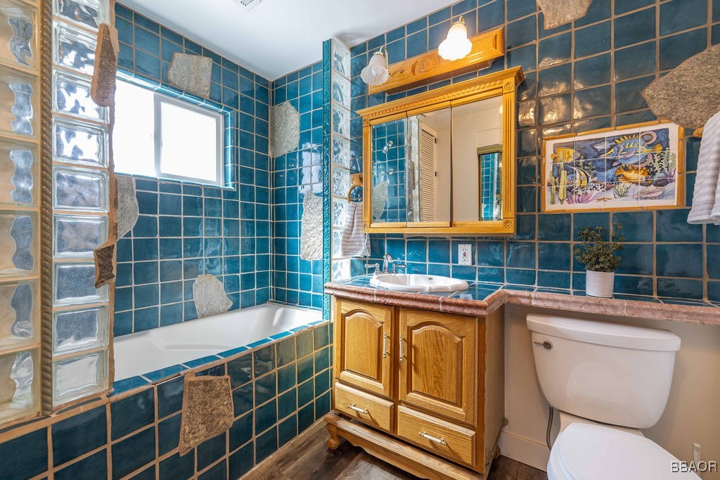 684 Chipmunk Lane Big Bear Lake, CA 92315 - Photo 14 of 49 a bathroom with a granite countertop sink a toilet and shower