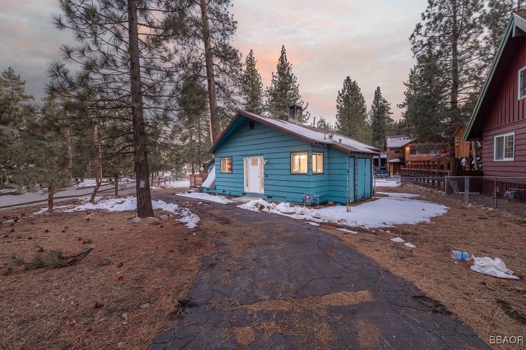 684 Chipmunk Lane Big Bear Lake, CA 92315 - Photo 31 of 49 a view of a house with a yard covered in forest