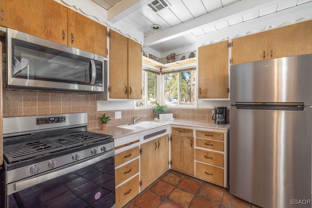 684 Chipmunk Lane Big Bear Lake, CA 92315 - Photo 8 of 49 a kitchen with a stove microwave and refrigerator