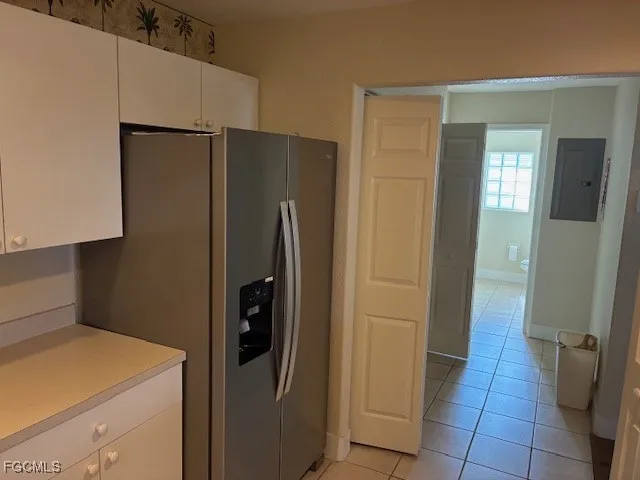a kitchen with a refrigerator and cabinets