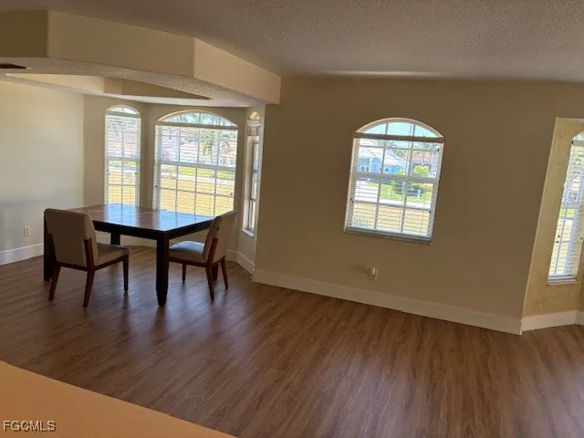 a view of a livingroom with furniture window and wooden floor