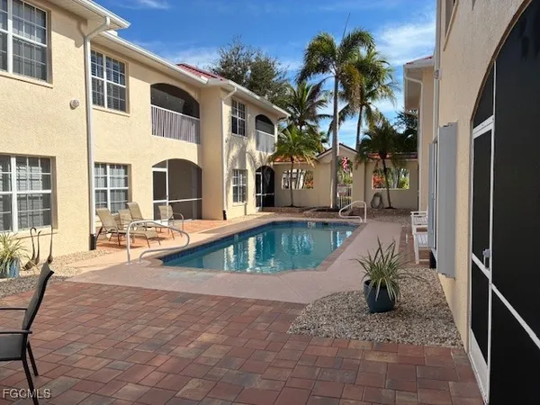 a view of a house with backyard and sitting area