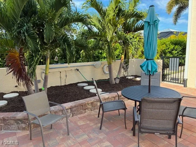 a view of a chairs and table in patio