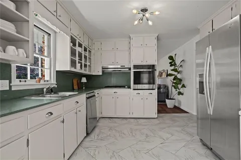 a kitchen with a sink and refrigerator