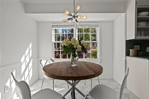 a view of a dining room with furniture window and outside view
