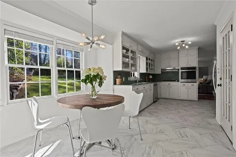 a kitchen with granite countertop a counter space appliances and cabinets