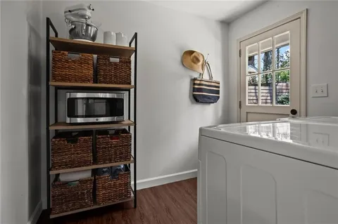 a kitchen with granite countertop a oven a cabinets and a wooden floor