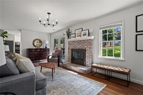 a living room with furniture a fireplace and window