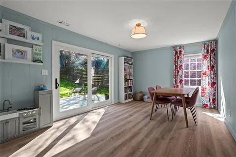 a view of a dining room with furniture window and wooden floor
