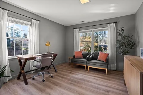 a view of a workspace with furniture and a window