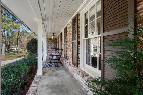 a view of a porch with furniture and garden