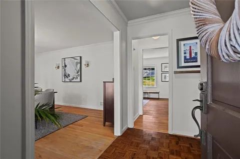 a view of hallway with furniture and wooden floor