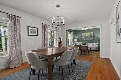 a view of a dining room with furniture window and wooden floor