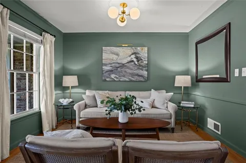 a living room with furniture and a potted plant