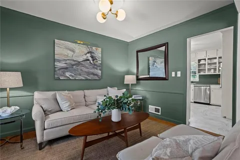 a living room with furniture and a potted plant