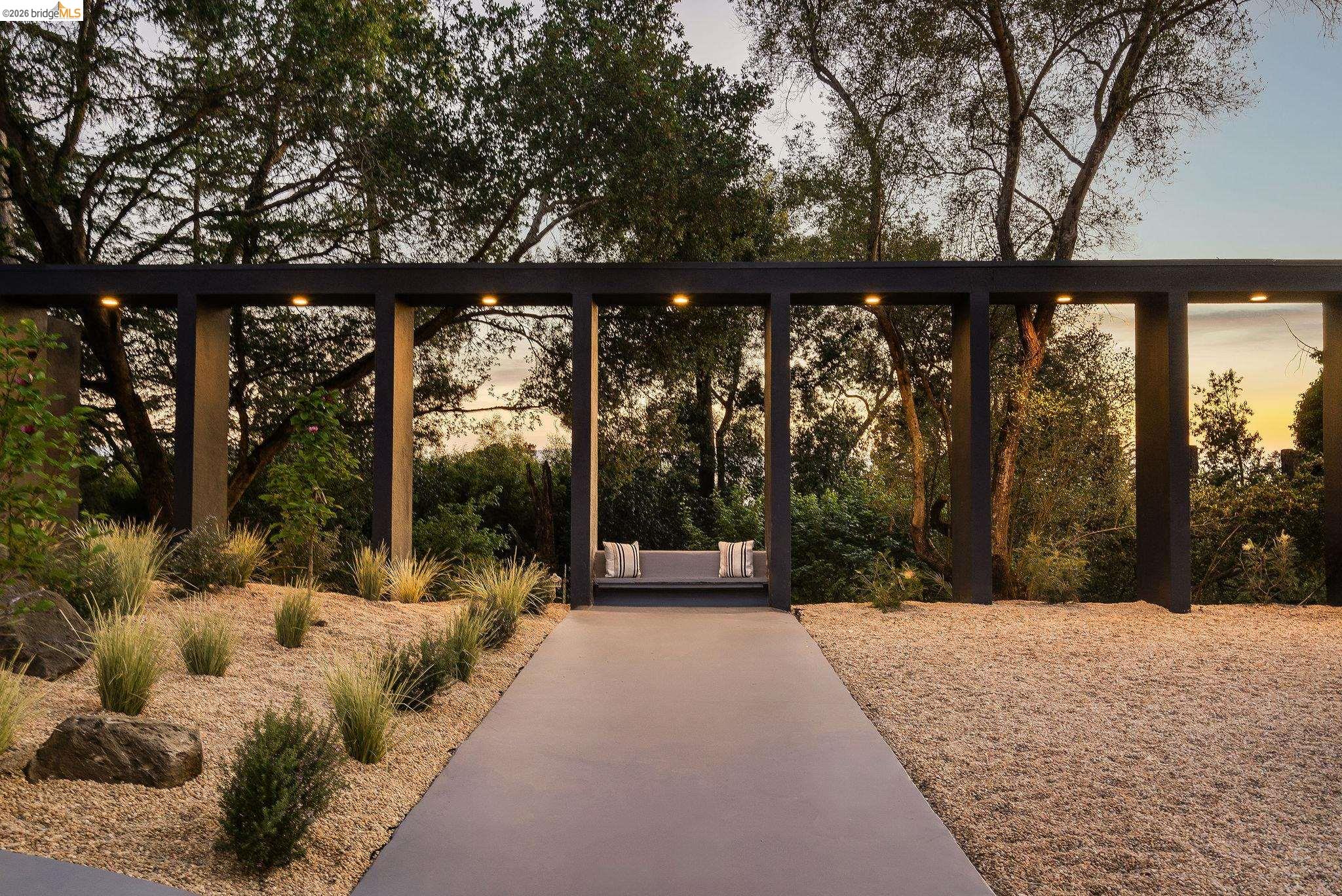 5645 Bacon Road Oakland, CA 94619 - Photo 78 of 94 Modern outdoor trellis with recessed lighting, integrated bench seating, and a concrete pathway