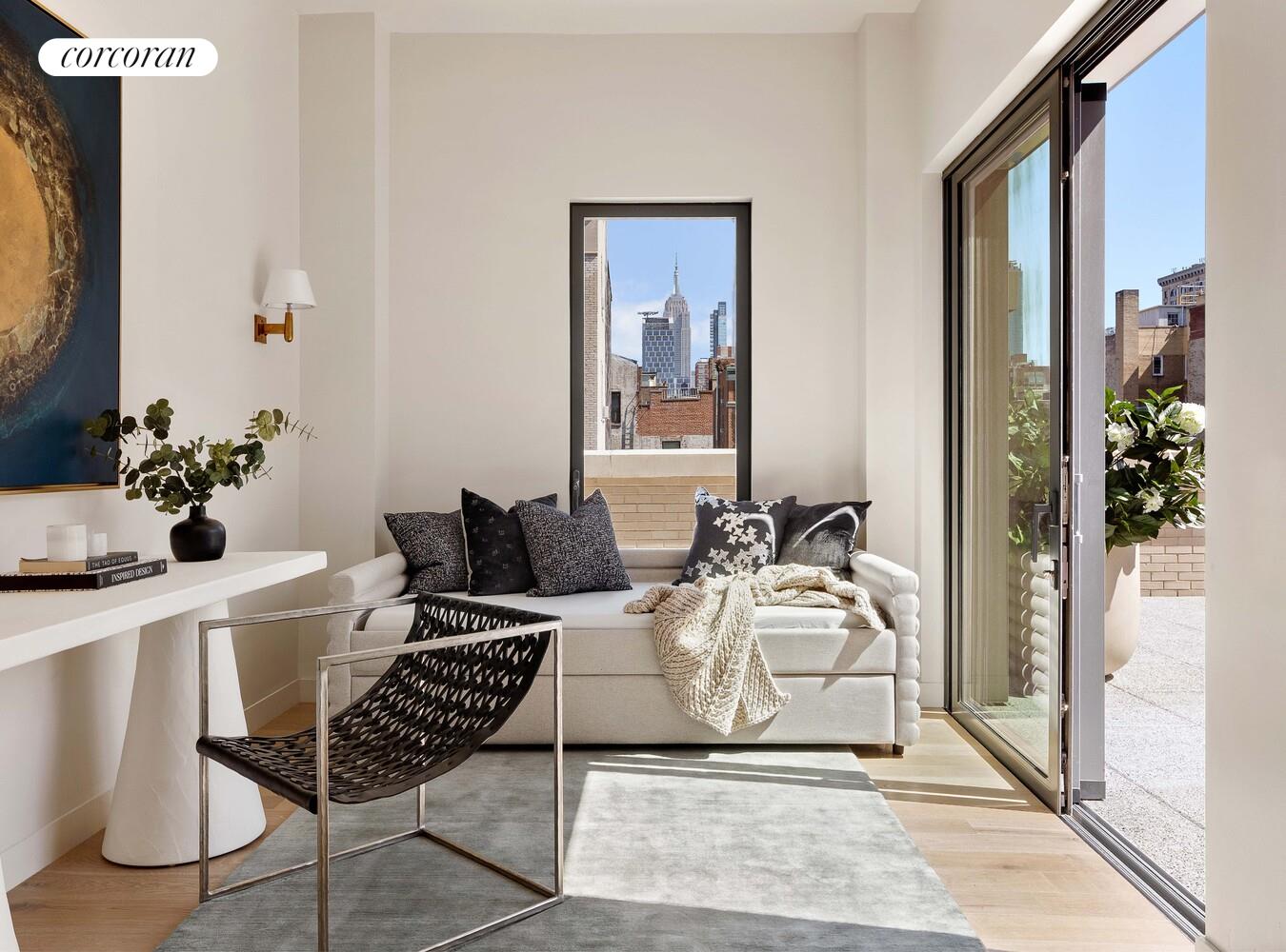 181 MacDougal Street, Unit PH Manhattan, NY 10011 - Photo 12 of 26 a living room with furniture a potted plant and a table