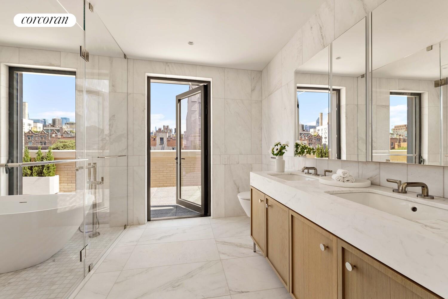 181 MacDougal Street, Unit PH Manhattan, NY 10011 - Photo 14 of 26 a spacious bathroom with a double vanity sink and a mirror